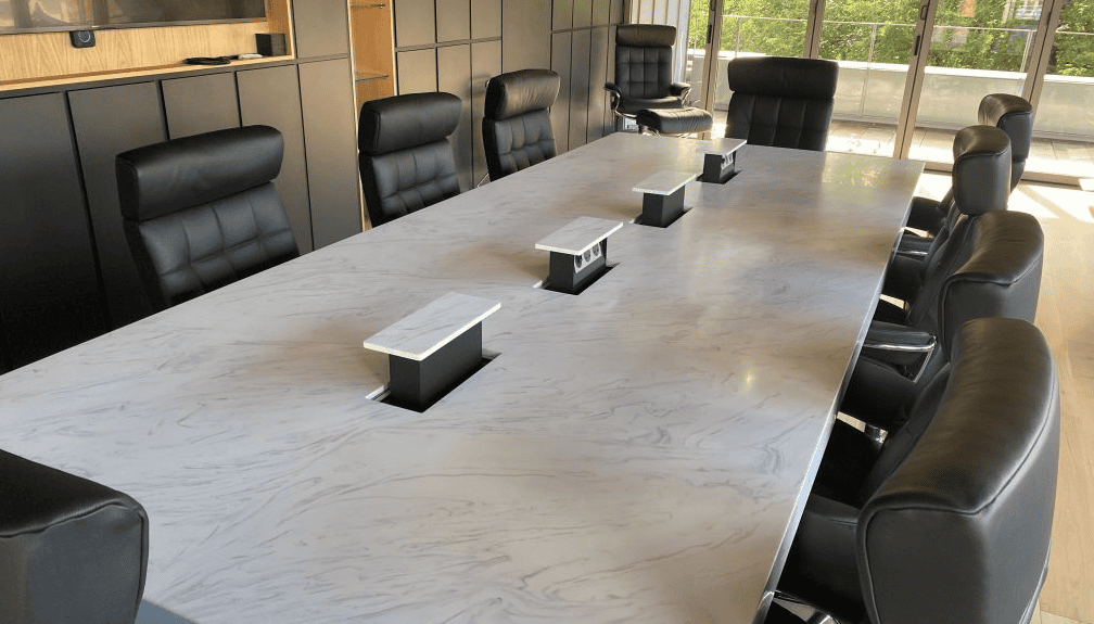 s-box installed on a solid surface meeting room table